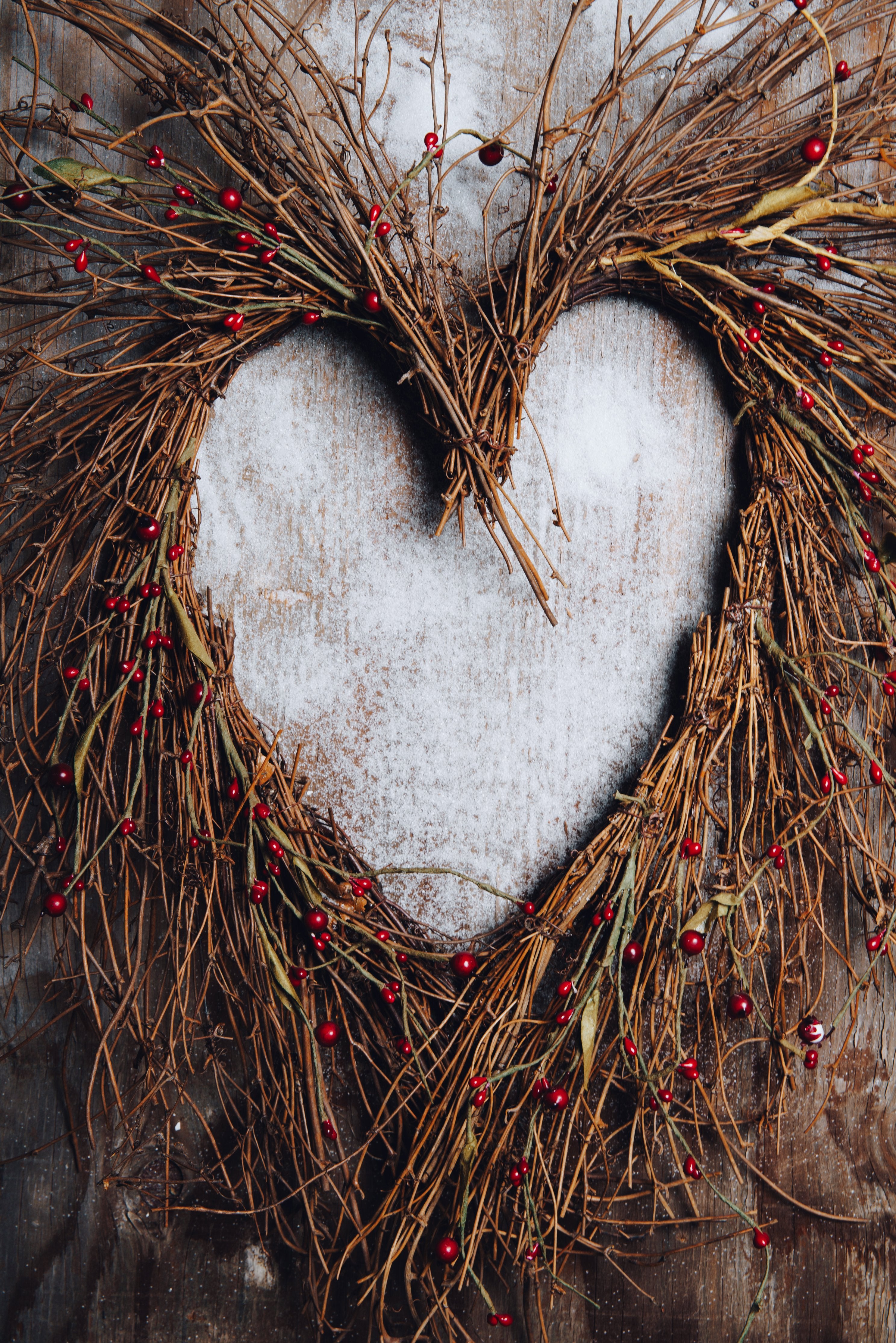 A wreath of twigs and natural materials in the shape of a heart
