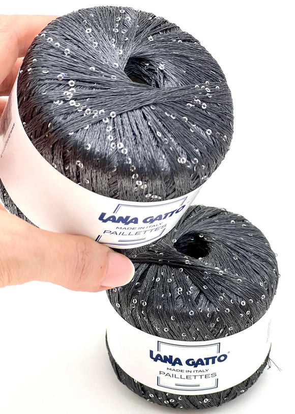 Two skeins of a black Paillettes yarn