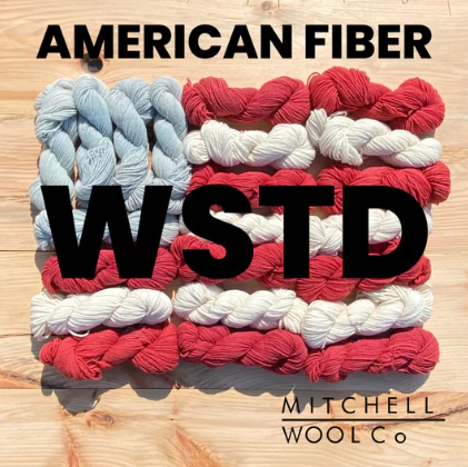 Colorful yarn skeins with 'American Fiber' and 'Mitchell Wool Co.' branding on a wooden background.