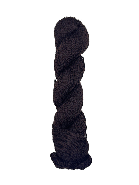 Dark Brown/Black skein of mountain meadow wool yarn on a white background