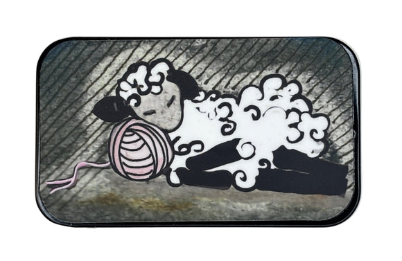 Small rectangular tin with a cartoon design of a sleepy sheep on a white background