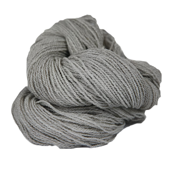 Light grey skein of fingering weight wool yarn