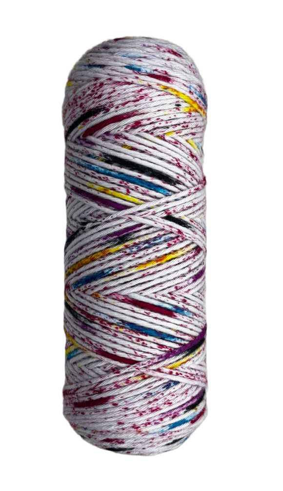 Black, red, yellow, blue speckled skein of yarn