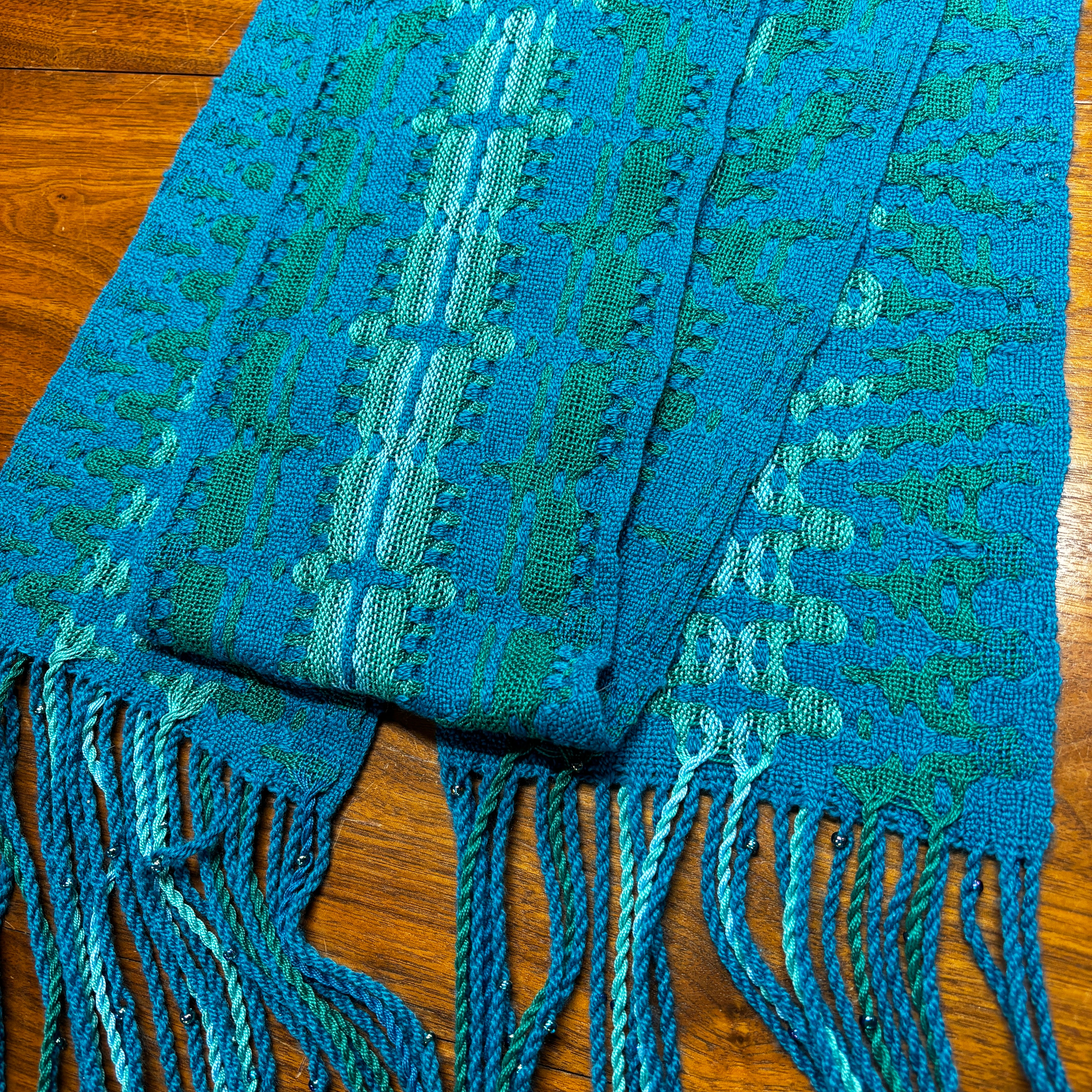 woven scarf in blue and green yarn