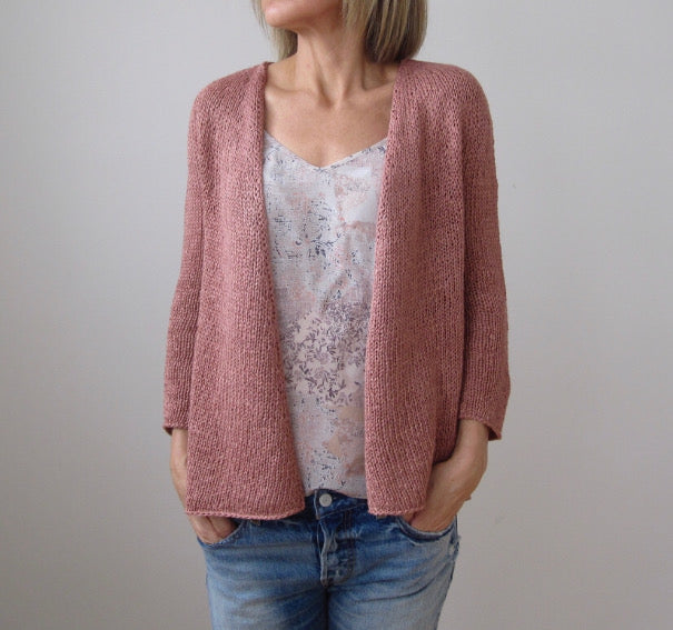 A rose pink quicksand cardigan on a woman.