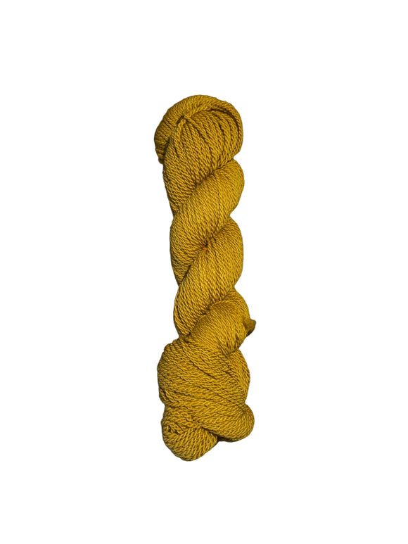 Yellow skein of mountain meadow wool yarn on a white background