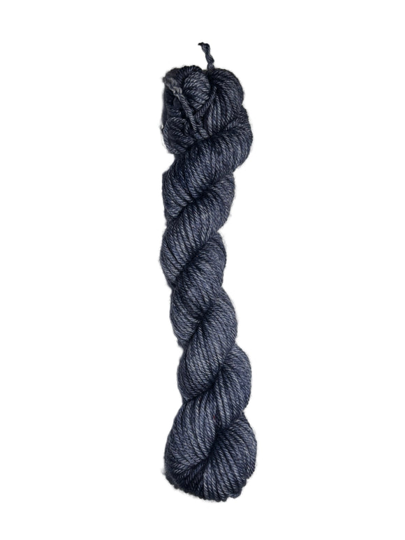Dark blue skein of wool yarn on a white background