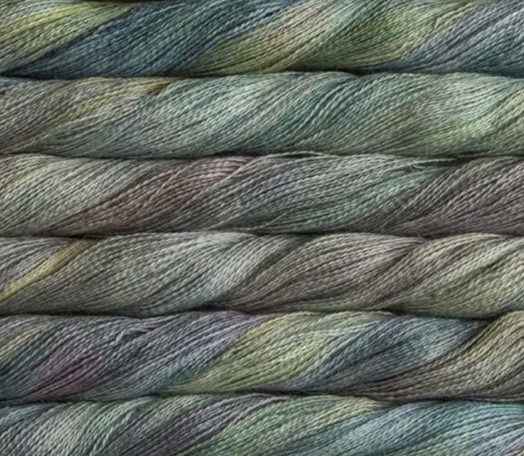 close up view of malabrigo silkpaca lace weight yarn color yellow grey blue light purple