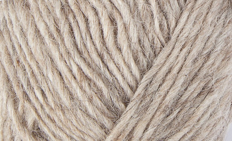 A close up photo of oatmeal colored  Istex Lettlopi yarn