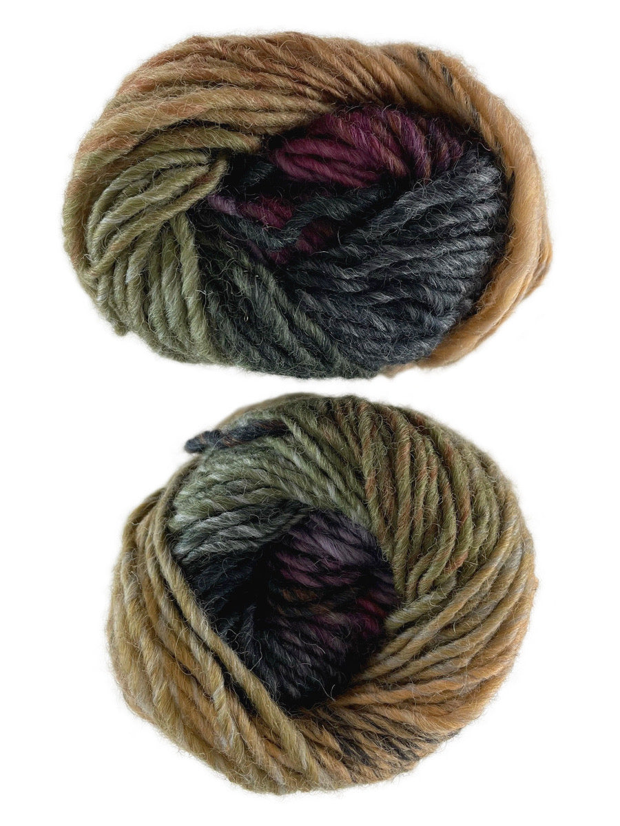 A photo of two black, green and tan skeins of yarn