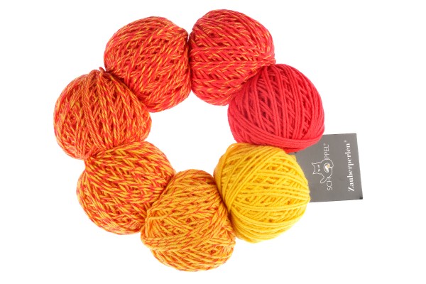 A yellow and orange set of Schoppel Zauber Perlen yarn balls