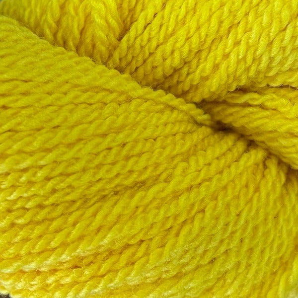 A yellow hank of the Mountain Meadow Wool Saratoga yarn collection