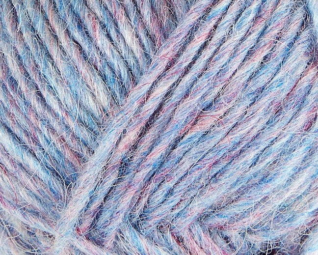 A close up photo of light blue Istex Lettlopi yarn
