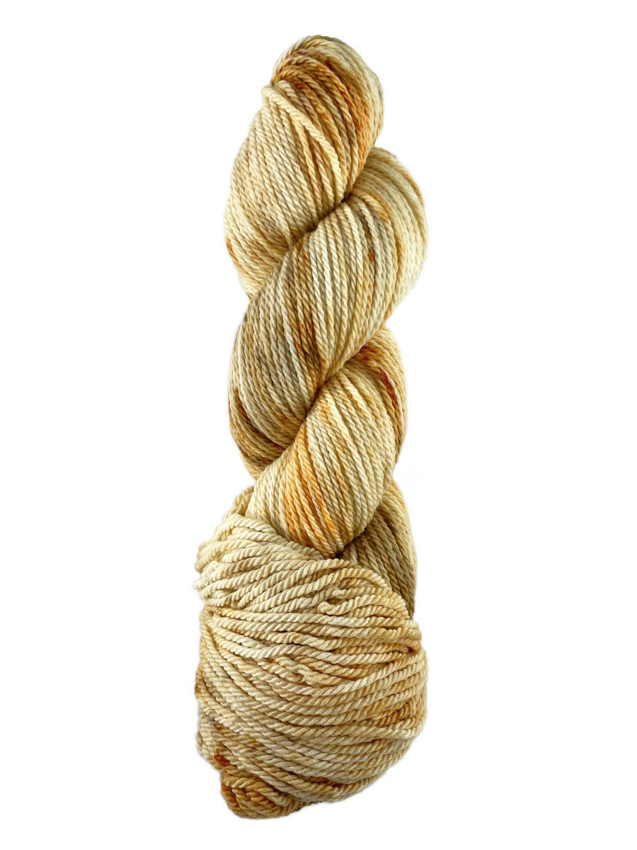An orange skein of Mountain Meadow Wool Cora yarn