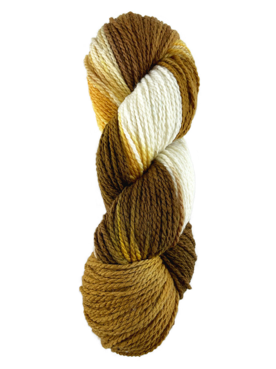 A brown, gold and white skein of Mountain Meadow Wool Cowboy Joe yarn