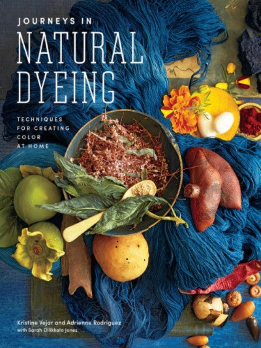 Cover of Journeys in Natural Dyeing- plants sit atop a pile of blue yarn