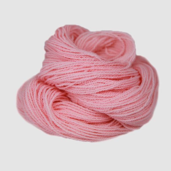 A light pink hank of the Mountain Meadow Wool Saratoga yarn collection