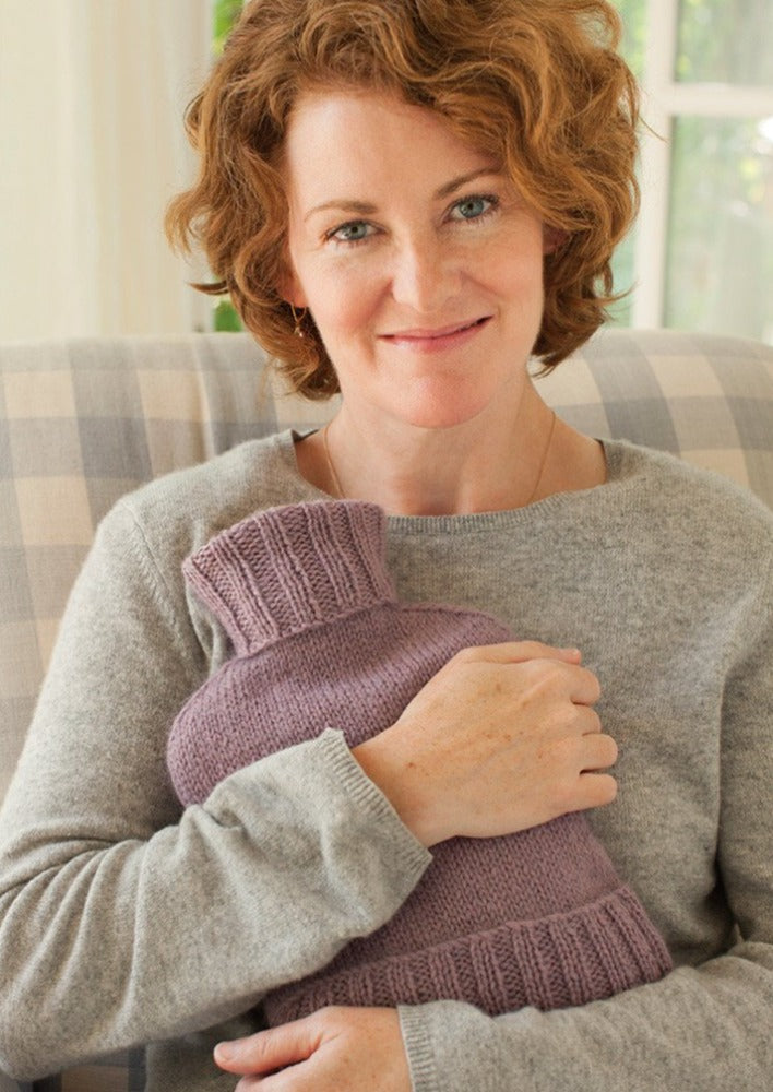 Woman holding hot water bottle cover