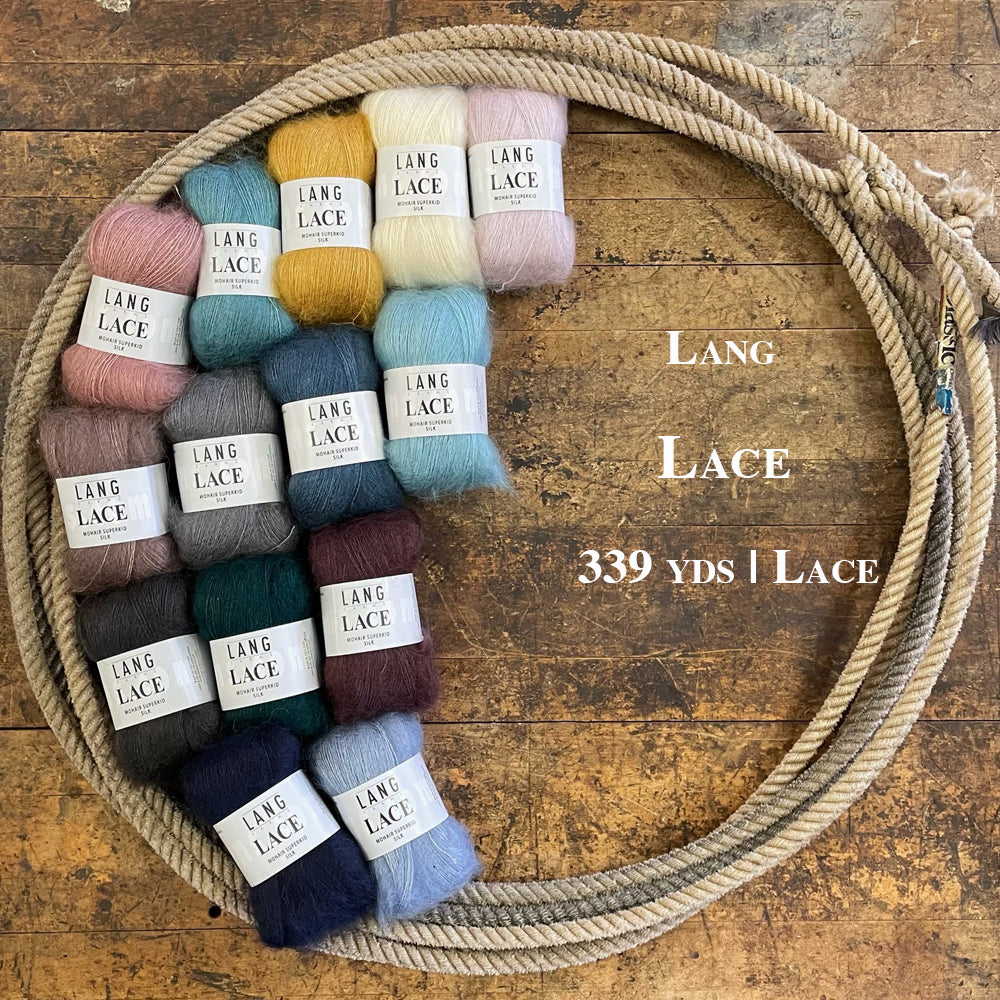 A photo of many different skeins of lang lace yarn in a lasso on a wooden surface