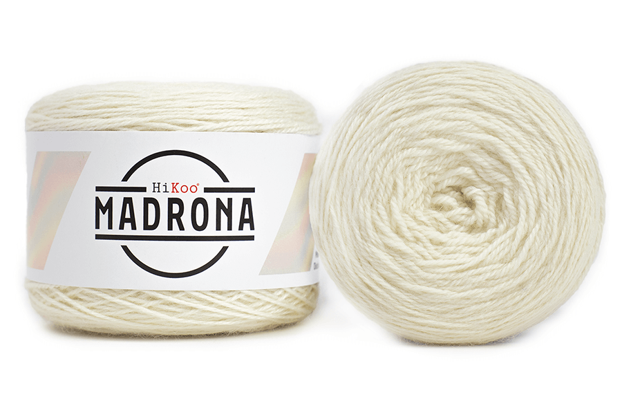 A photo of two white cakes of Hikoo Madrona yarn