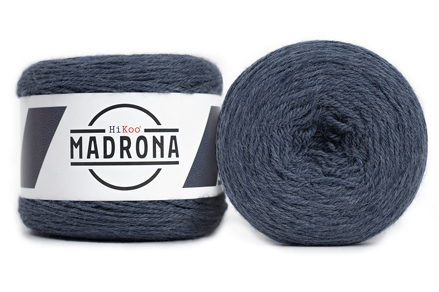 A photo of two blue cakes of Hikoo Madrona yarn