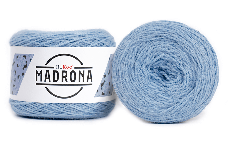 A photo of two light blue cakes of HiKoo Madrona yarn