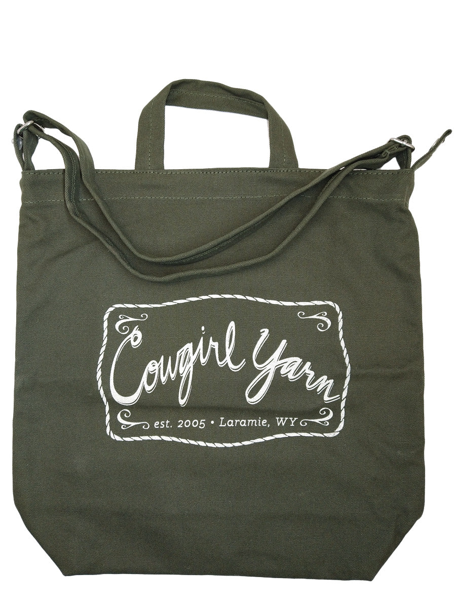 A cedar colored duck canvas bag with the Cowgirl Yarn logo