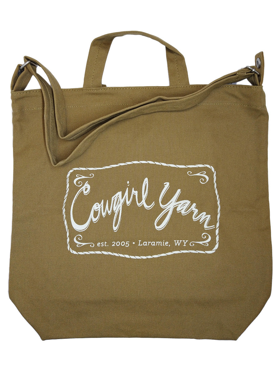 A khaki duck canvas bag with the Cowgirl Yarn logo