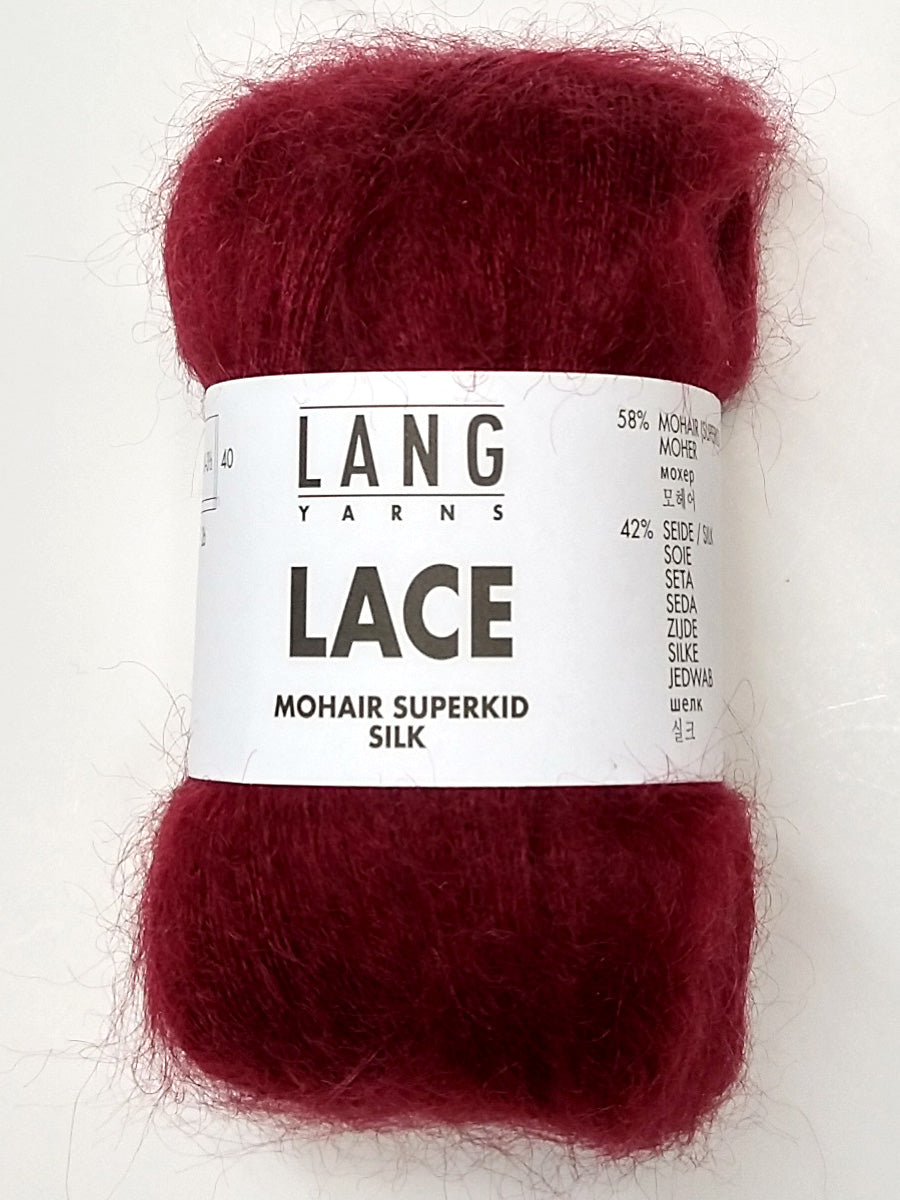 A photo of a burgundy skein of Lang Lace yarn.