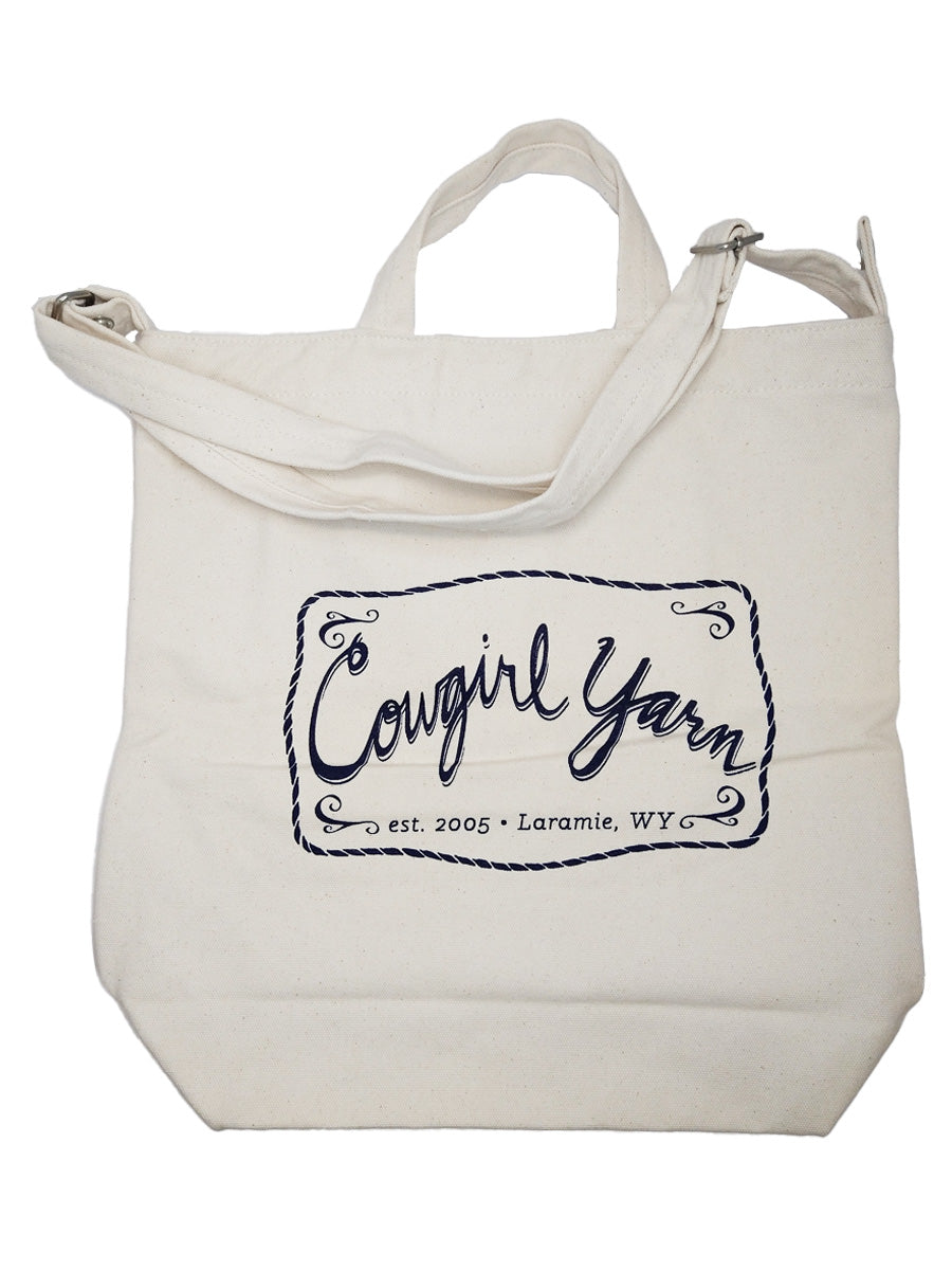 A white duck canvas bag with navy Cowgirl Yarn logo