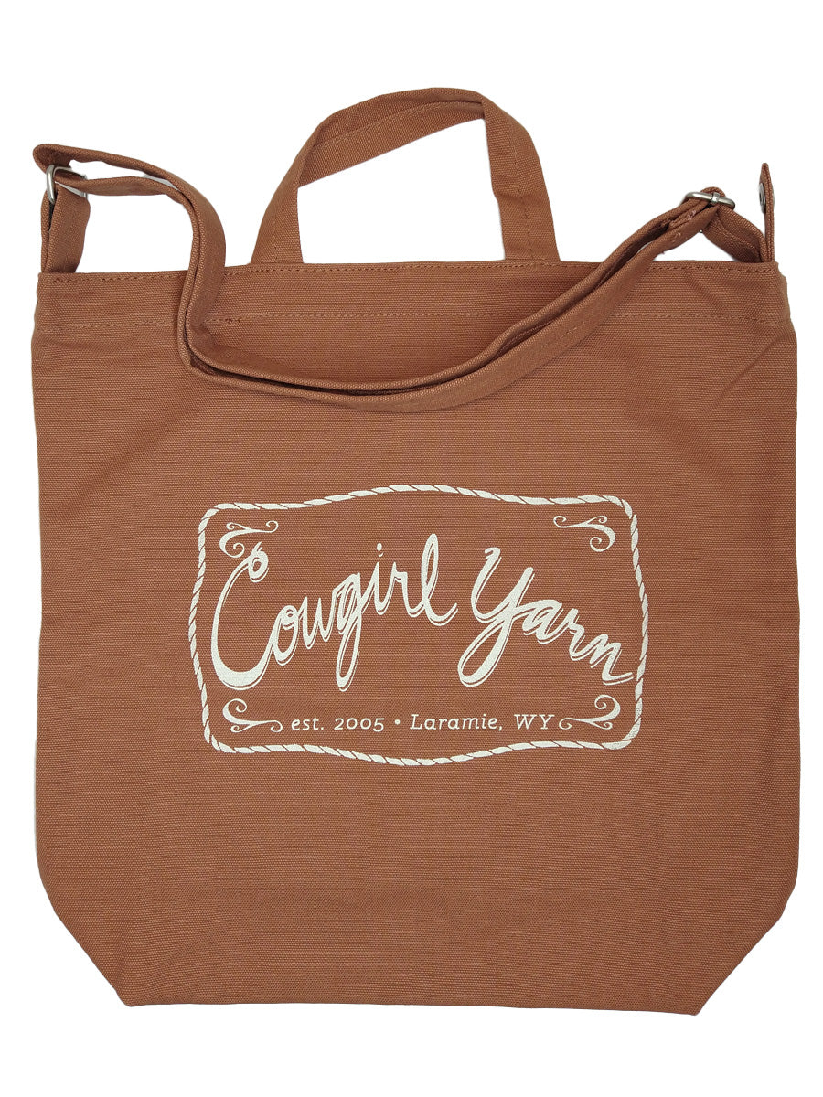 A pinto colored duck canvas bag with the Cowgirl Yarn logo
