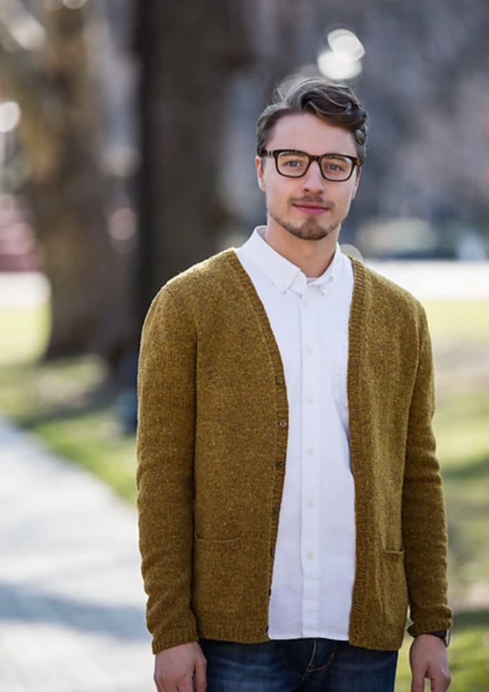 A man wearing a knitted cardigan