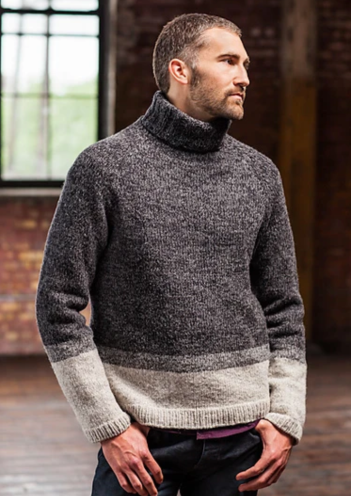 A man wearing a knitted turtleneck sweater