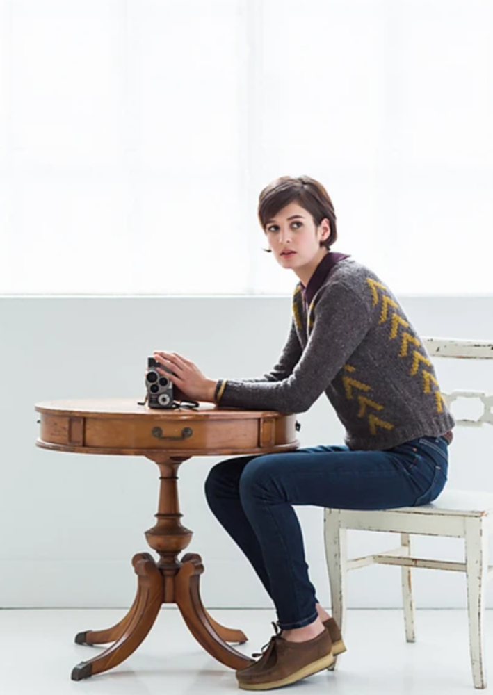 A sitting woman wearing a knitted sweater