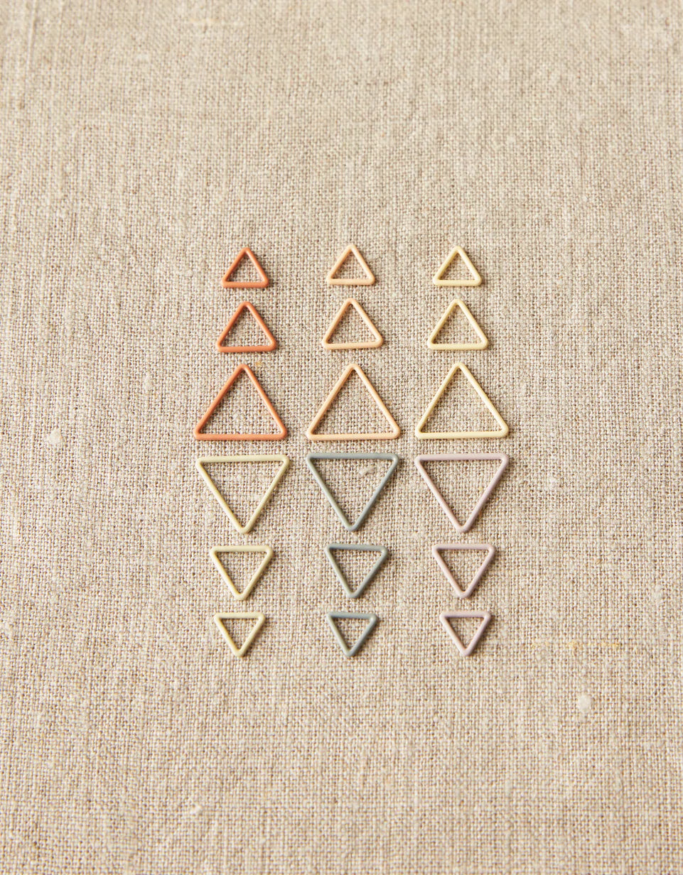 Cocoknits Triangle Stitch Markers - Earth Tones on linen background