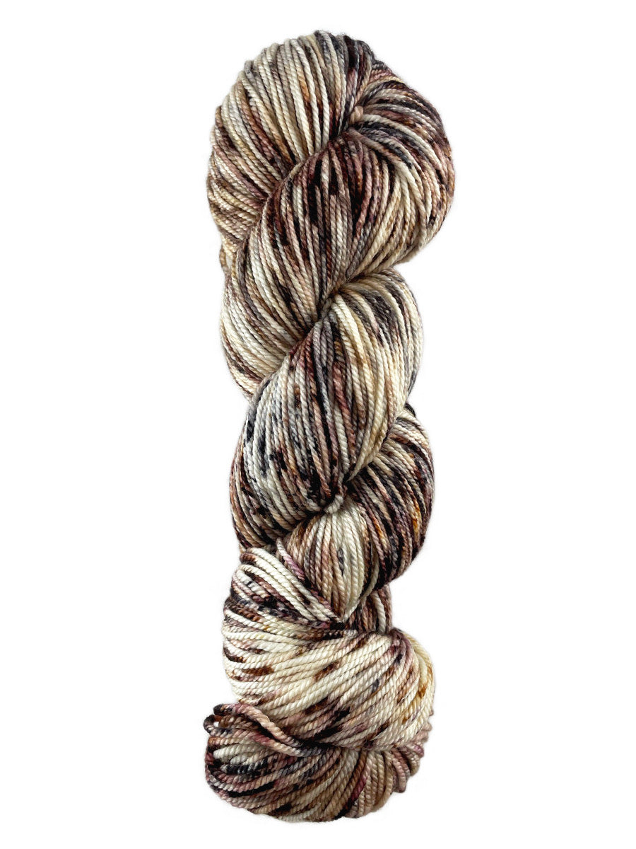 A brown and tan skein of Western Sky Knits Merino 17 DK yarn