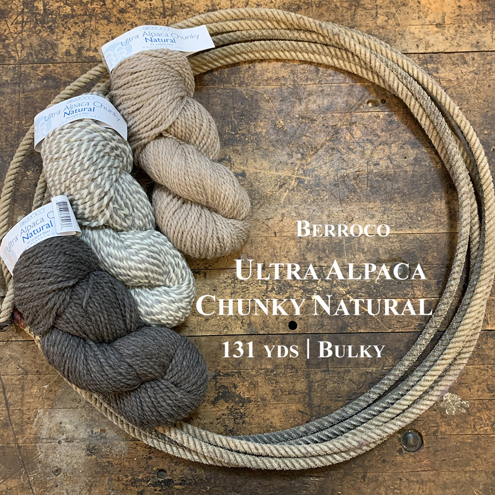 A photo of three hanks of Berroco Ultra Alpaca Chunky Natural in a lasso on a wooden surface