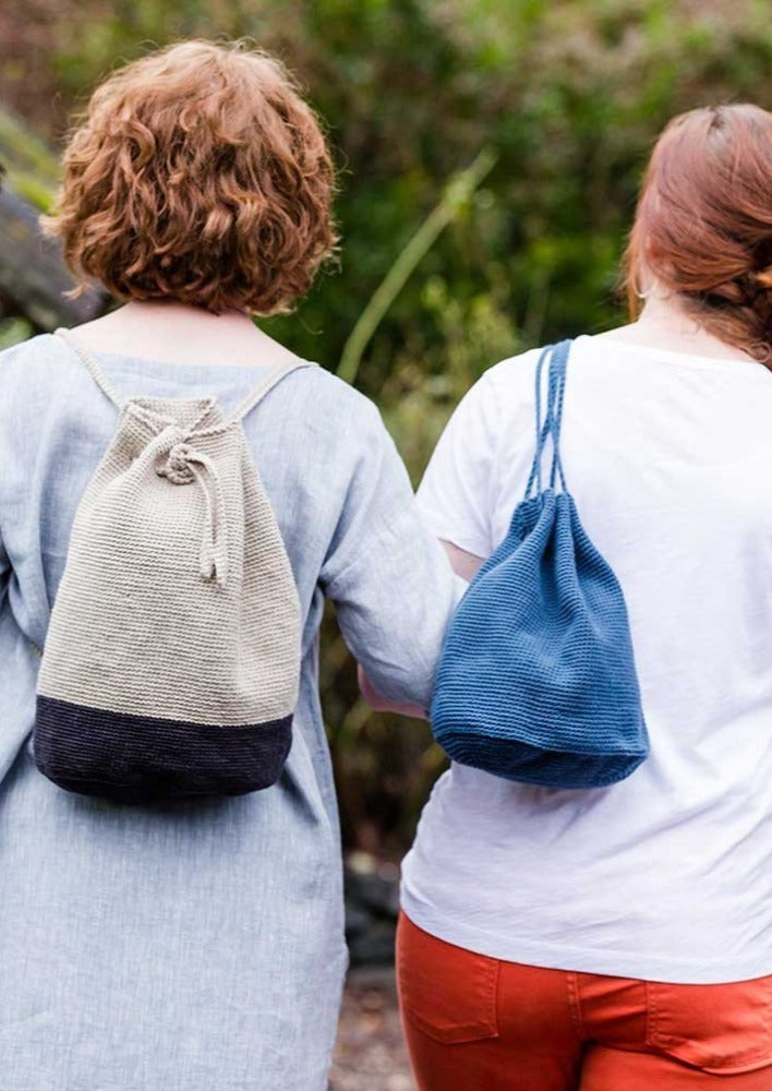 Two women wearing bags