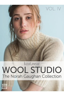 The book cover of "Wool Studio: The Norah Gaughan Collection," which features a woman wearing a knitted sweater looking at the reader.