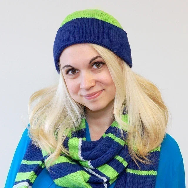Woman wearing a knit blue and green hat and scarf