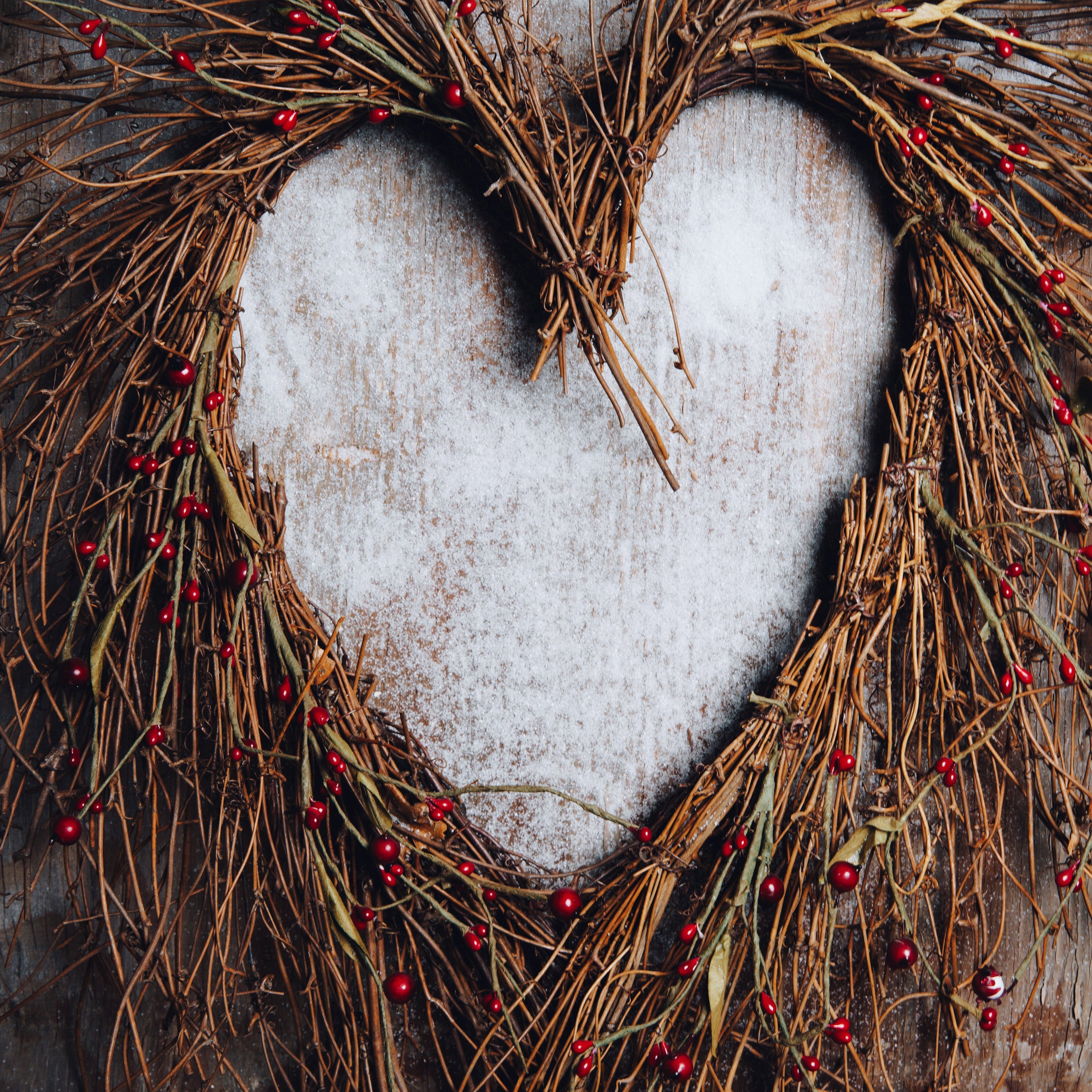 A wreath of twigs and natural materials in the shape of a heart