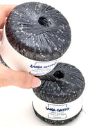 Two skeins of a black Paillettes yarn