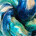a braid of ready to be spun fiber color blue, teal