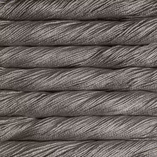 A close-up texture shot of twisted gray yarn or thread stacked horizontally, showing the fine strands and heathered gray color.