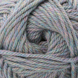 A close-up of twisted yarn wound into a skein, showing a variegated color mix of dusty blue, sage green, lavender, and soft pink.