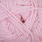 A close-up of soft pink yarn strands twisted together, filling the frame.