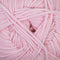 A close-up of soft pink yarn strands twisted together, filling the frame.