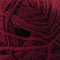 A close-up of a ball of deep burgundy yarn, showing the twisted plies and soft texture of the wool.
