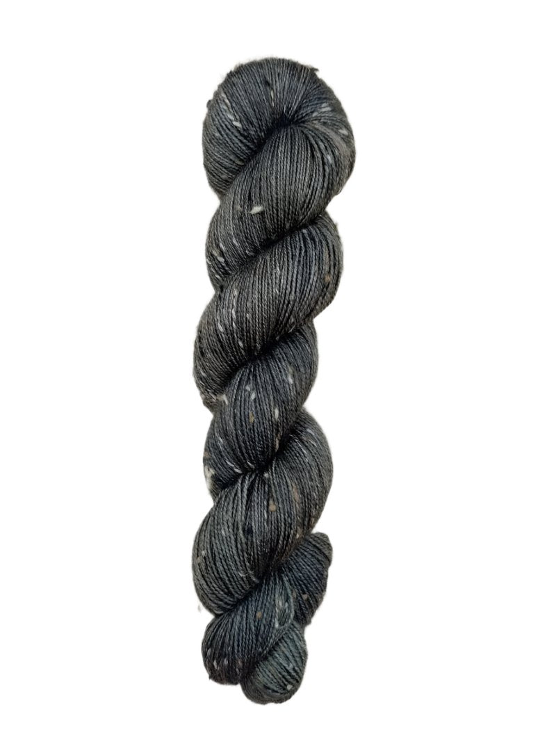 Skein of hand dyed BFL Tweed Yarn color steel grey 