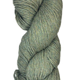 A skein of Berroco Vintage Worsted yarn color Okra green with blue and yellow marl